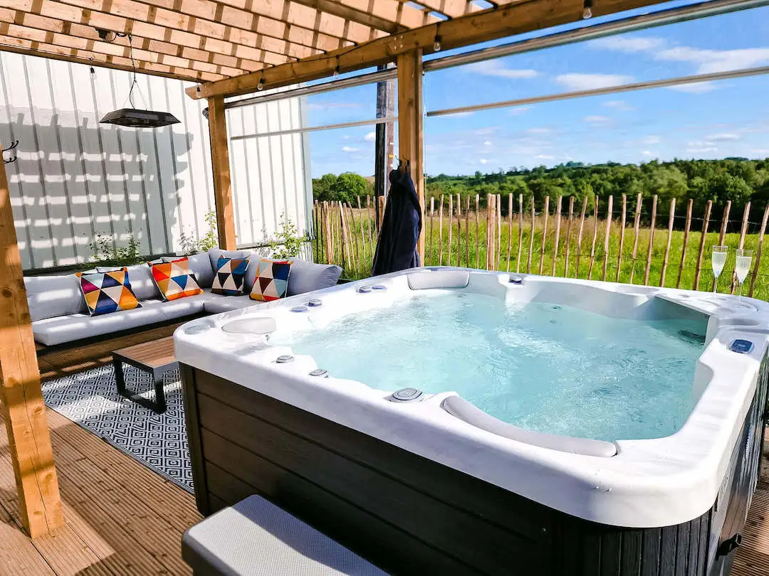 This is a premium hottub on a deck overlooking countryside views at a luxury accommodation in Northern Ireland.